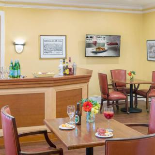 A cozy restaurant interior featuring a bar counter and dining tables.