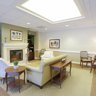 A cozy living room with elegant furnishings, including a fireplace, sofa, and coffee table.