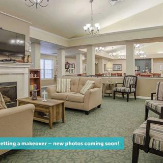 A cozy living room with comfortable seating and a fireplace, undergoing a makeover.