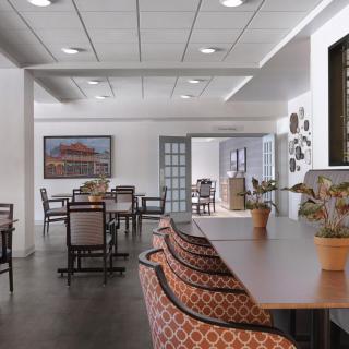 A modern dining area with neatly arranged tables and chairs, featuring stylish decor.