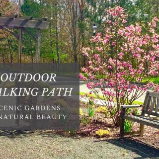 A scenic outdoor walking path surrounded by gardens and natural beauty.