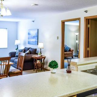 A cozy living space featuring a kitchen and dining area with stylish furniture and decor.