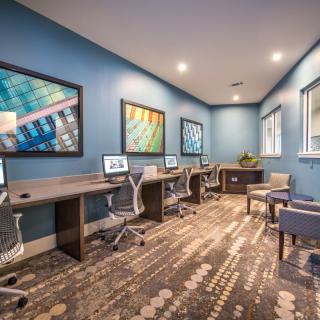 A modern office space with multiple workstations equipped with computers and stylish decor.