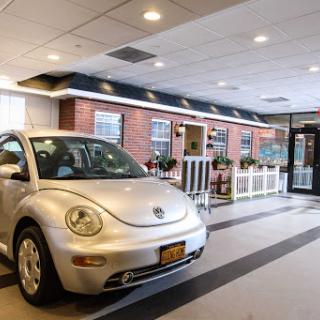 A silver Volkswagen Beetle parked inside a modern restaurant with a stylish interior.