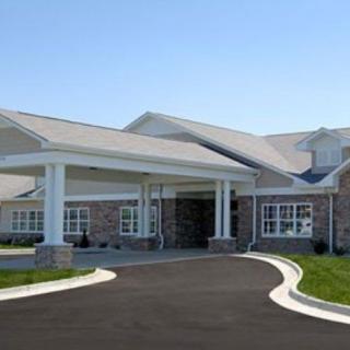 A modern building with a covered entrance and driveway.