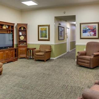 A cozy living room with comfortable armchairs and a television.