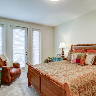 A cozy bedroom with classic wooden furniture and ample natural light.