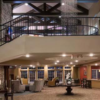 A modern and cozy lobby area with comfortable seating, stylish lighting, and open architectural design.