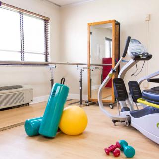 A fitness room equipped with exercise machines and various workout tools.