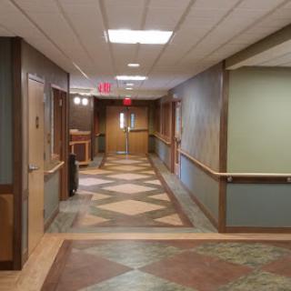 A well-lit interior hallway showcasing patterned flooring and a welcoming atmosphere.
