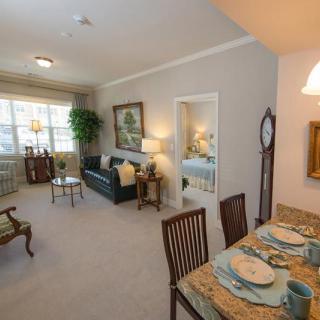 A cozy living room with a dining area, featuring elegant furniture and decor.