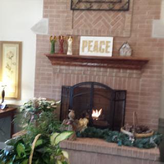 A warm and inviting living room featuring a beautifully decorated fireplace with a focus on peace.