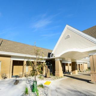 A sunny view of a building entrance with clear blue skies.