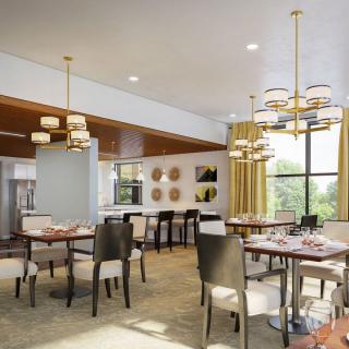 A modern restaurant interior with elegant dining tables, chairs, and stylish lighting.