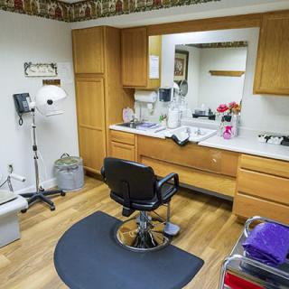 A medical examination room equipped with a chair and various medical instruments.