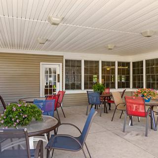 A cozy outdoor patio with colorful seating and plants, perfect for relaxation.