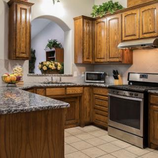 A warm and inviting kitchen featuring wooden cabinetry and modern appliances.