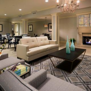 A modern living room with chic furniture and a cozy fireplace.
