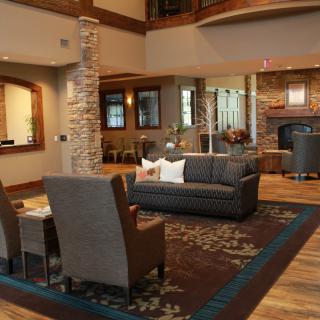 A modern lobby area featuring comfortable seating, a fireplace, and elegant decor.