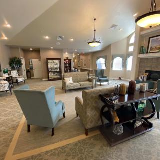 A spacious and modern living room with stylish furniture and ample lighting.