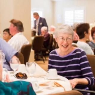 A group of people enjoying a meal together at a social event indoors.