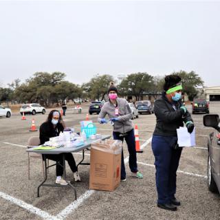 Volunteers assisting people at a community health event.