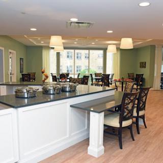 A modern dining area featuring comfortable seating and ample natural light.