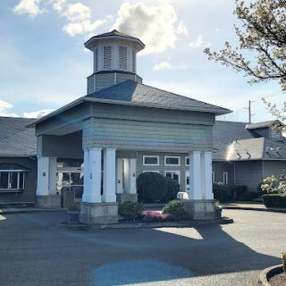 A welcoming entrance to a well-designed building under a clear sky.