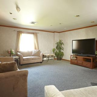 A cozy living room with sofas, a television, and a coffee table.