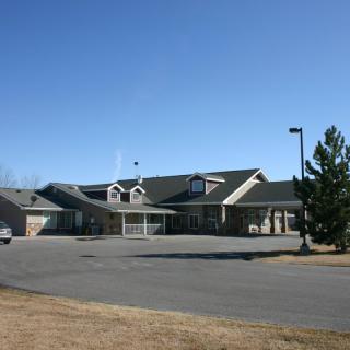 A suburban house with a driveway and clear blue sky.