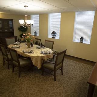 A well-decorated dining room with a set table and elegant lighting.