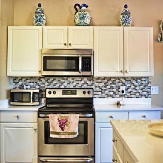 Modern kitchen with stainless steel appliances and decorative elements.
