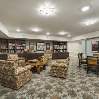 A cozy library interior with comfortable seating and bookshelves.
