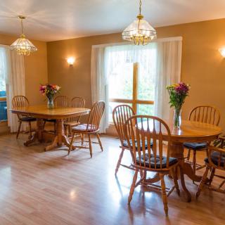 A cozy dining room with wooden furniture and natural light.