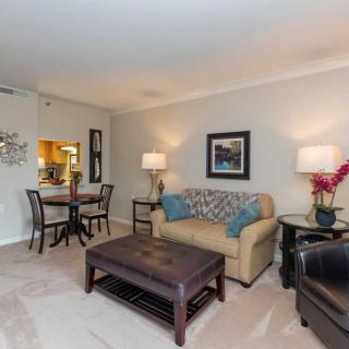 A cozy living room with a neutral color scheme, featuring a sofa, dining table, and stylish decor.