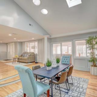 A modern, open-concept living and dining area with abundant natural light and stylish furniture.