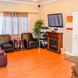 Cozy living room with a fireplace, television, and comfortable seating.