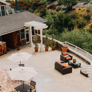 Spacious outdoor patio with furniture and a scenic view.