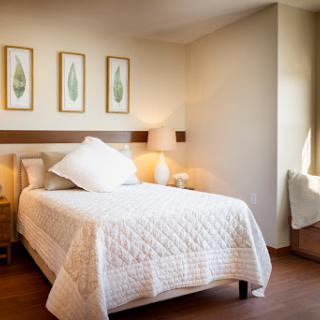 A beautifully designed modern bedroom with minimalist decor and natural light.