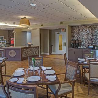 A cozy dining area with neatly set tables and ambient lighting.