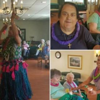 Elderly residents enjoy a hula dance performance at a community event.