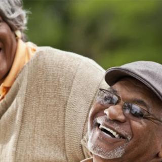 A joyful moment shared by an elderly couple enjoying the outdoors.