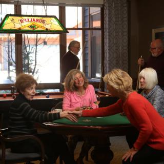 A group of women enjoying a card game indoors.