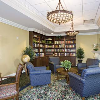 A cozy library lounge with comfortable seating, bookshelves, and decorative elements.