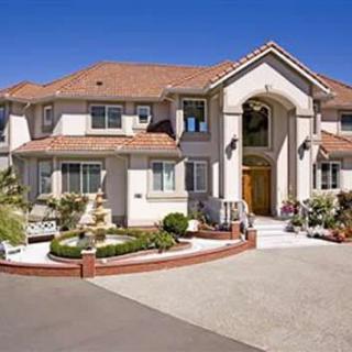 Beautiful luxury suburban house with landscaped front yard.