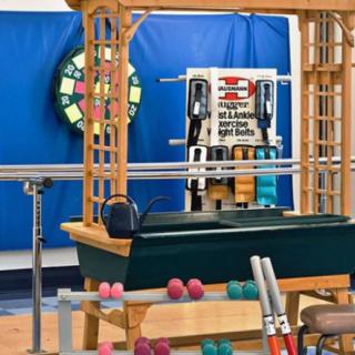 A gym setup featuring various exercise equipment including weights, a barbell, and a kettlebell.