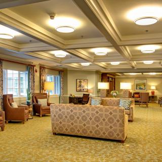 A spacious and well-lit lounge area with comfortable seating and elegant decor.