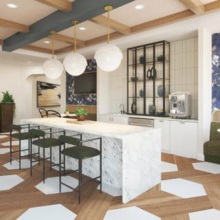 A modern kitchen featuring a central island with sleek bar stools, pendant lighting, and stylish cabinetry in an open and contemporary space.