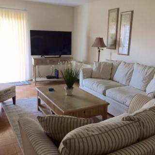 A cozy living room with a comfortable sofa, coffee table, and television.