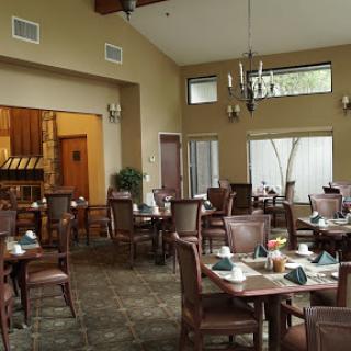 A cozy dining area featuring elegant furniture and warm lighting.